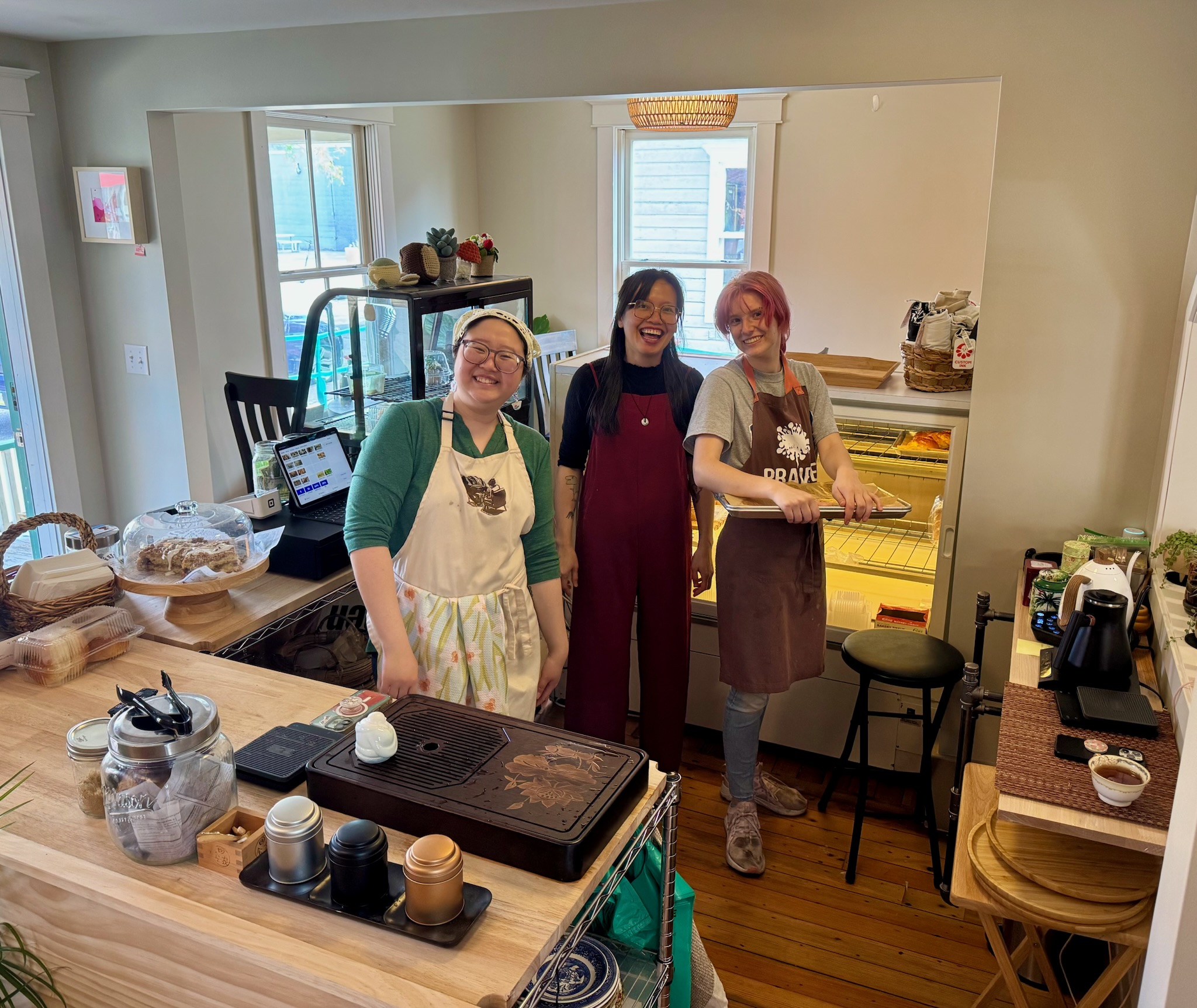 Vi, Haley, and Anh, ready to pour tea